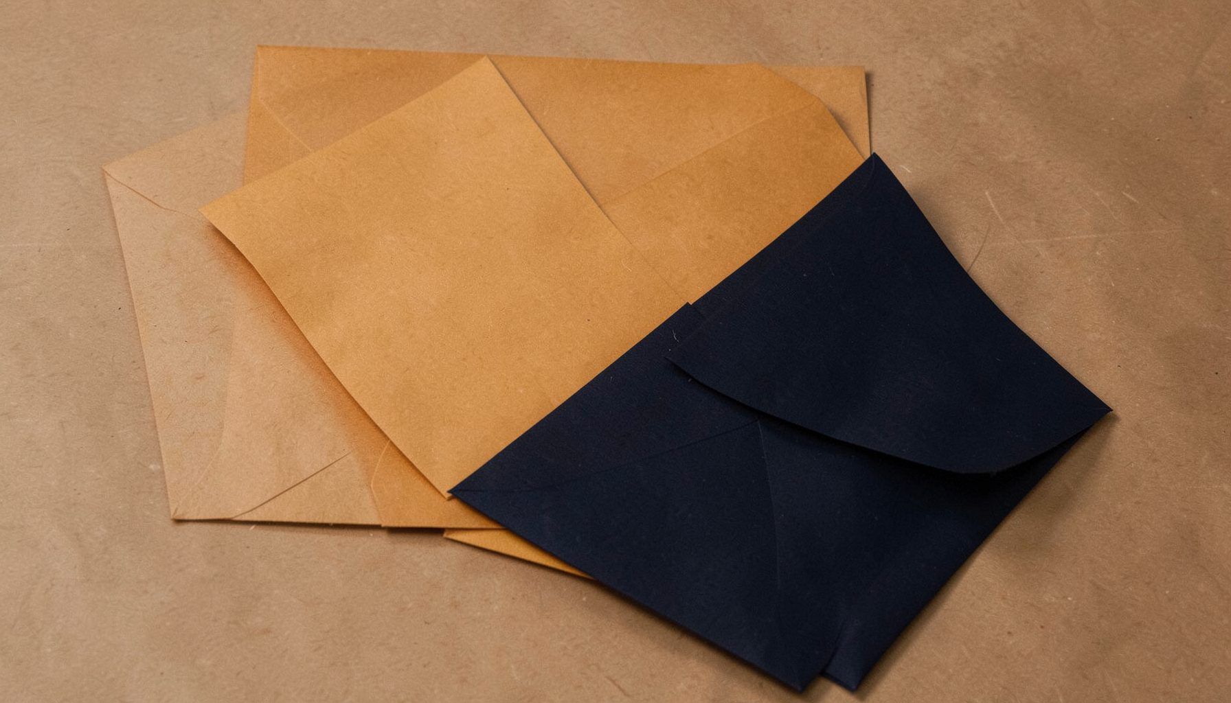 Abstract composition of layered paper documents and envelopes in warm amber and deep navy tones, scholarly mood